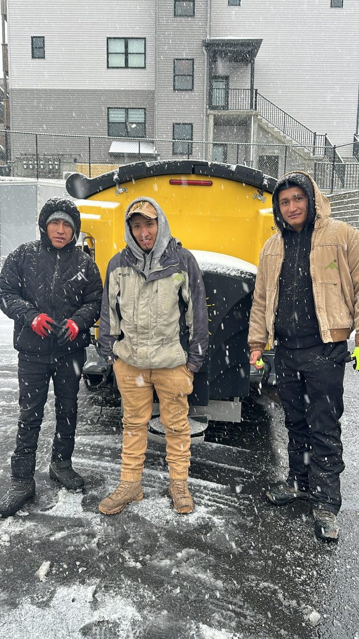 Shaleg Landscaping crew in front of a salt spreader truck in the snow